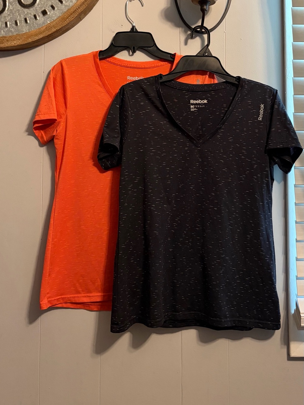 Bundle of 2 Reebok Women’s Short Sleeve V-Neck Tops in Black and Orange